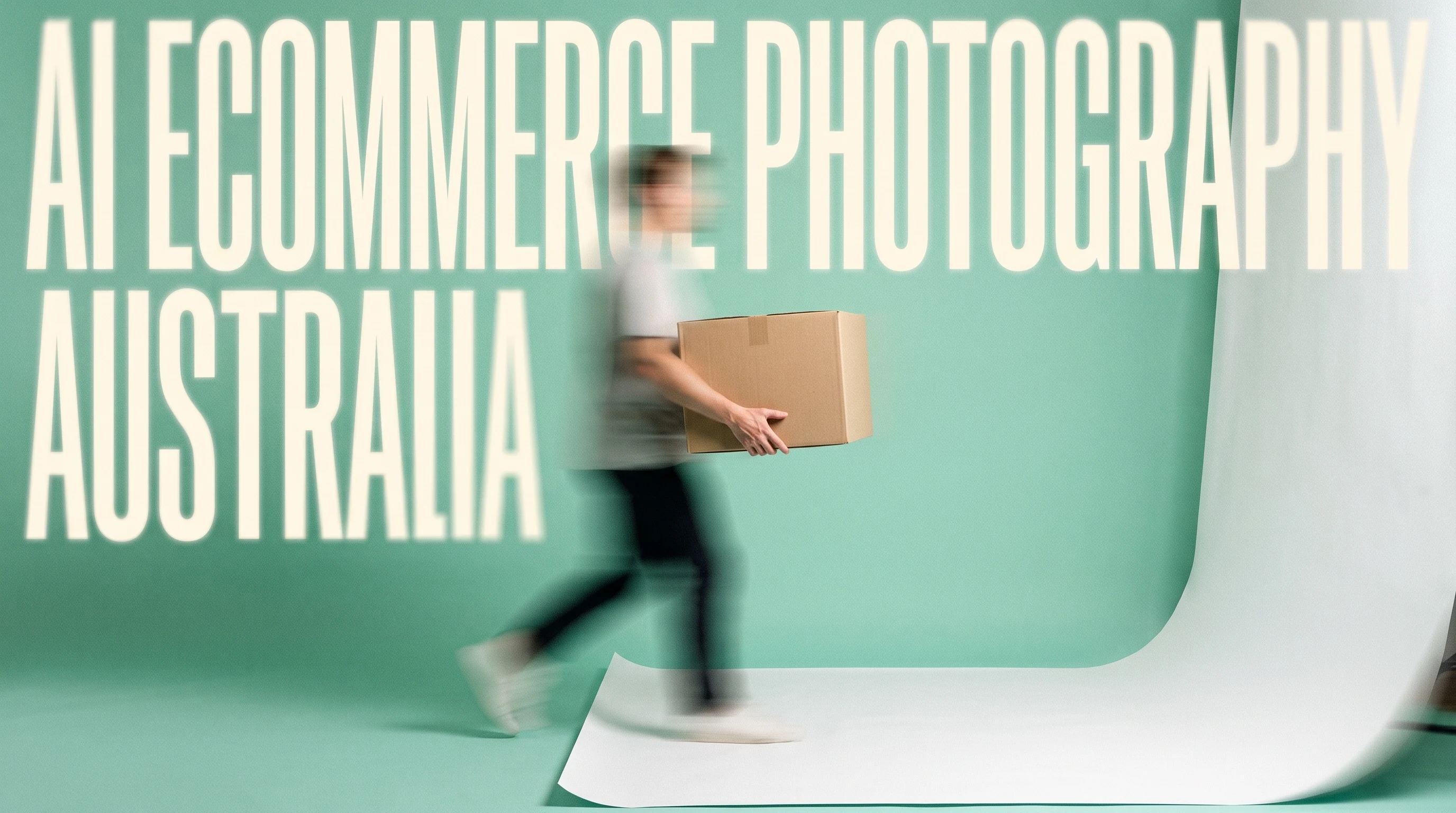 A person mid-step in a clean product-styling studio, mint-green backdrop, carrying a plain unbranded box toward a white paper sweep, three-quarter