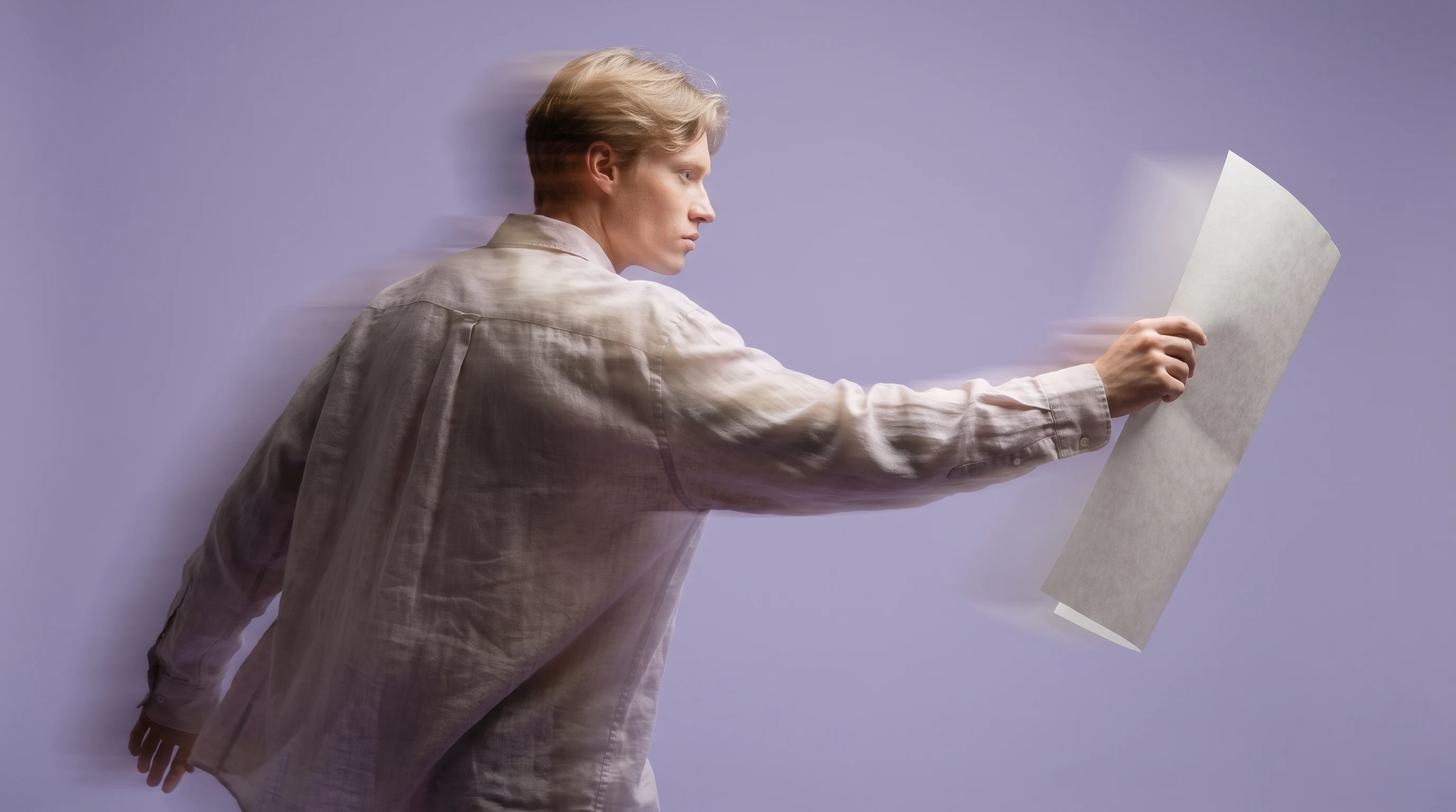 a person mid-turn in a lilac studio holding a large blank printed sheet at arm's length, profile framing, evaluating it like a crew call-sheet,
