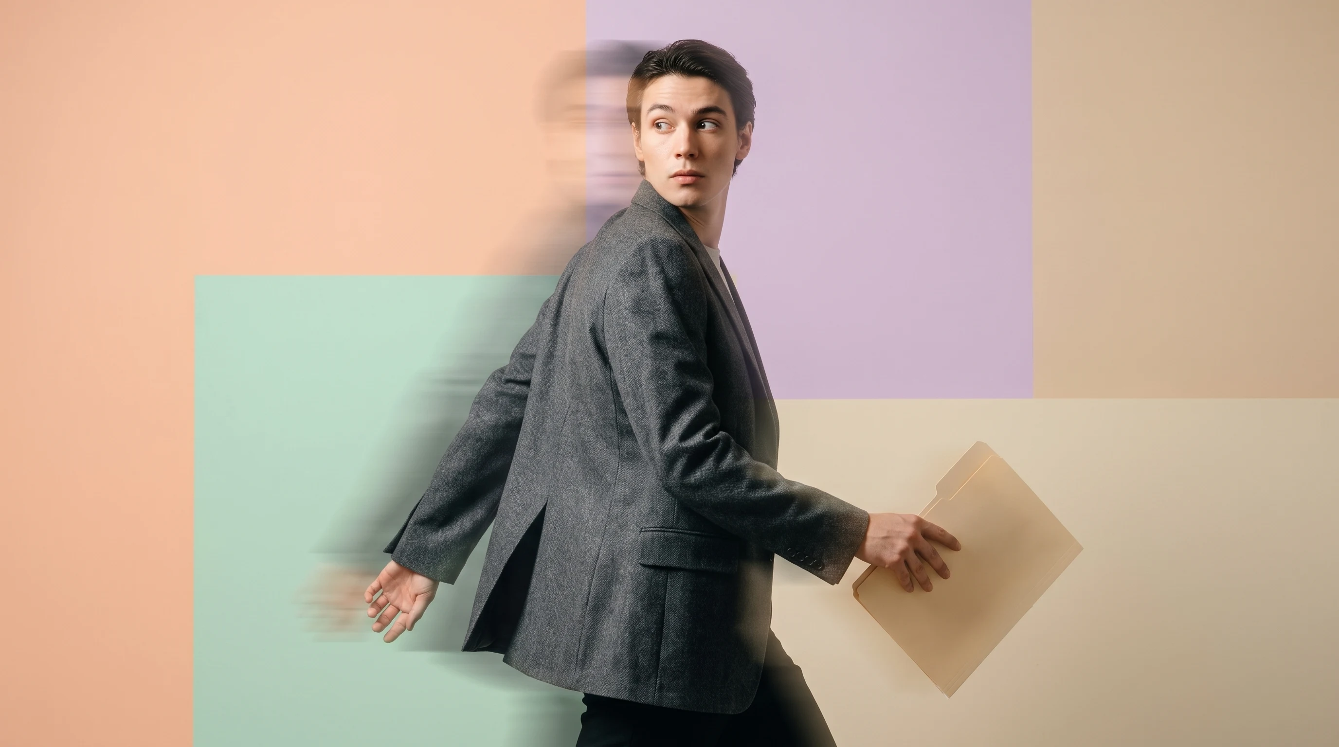 a person mid-step through a peach-backdrop studio in a tailored blazer, glancing over their shoulder, carrying a slim unbranded folder, profile